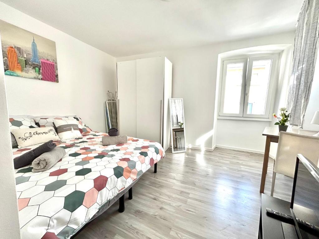 a white bedroom with a bed and a window at Residence Zar 1 in Trieste