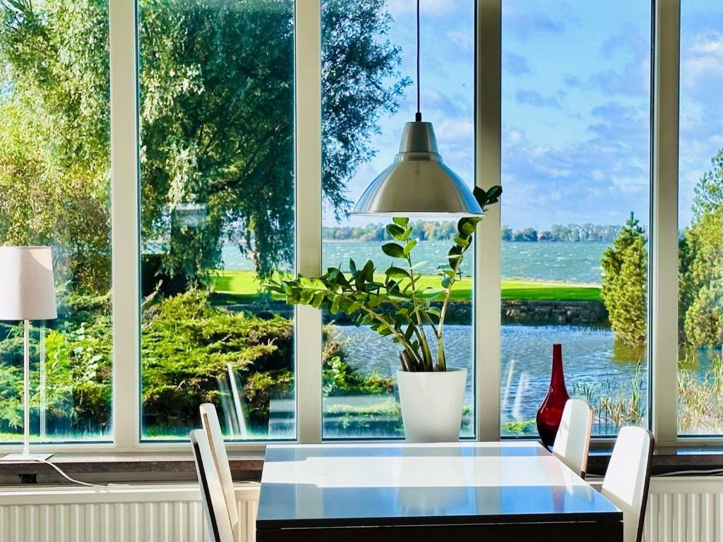a dining room with a table and a large window at Vadstena Folkhögskola Vandrarhem in Vadstena