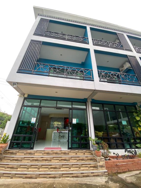a building with blue windows and steps in front at Love you Hotel in Phitsanulok