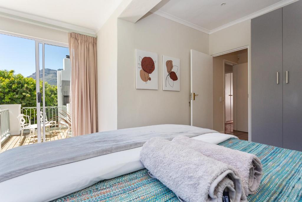 a bedroom with a large bed and a large window at Q on Westford in Cape Town