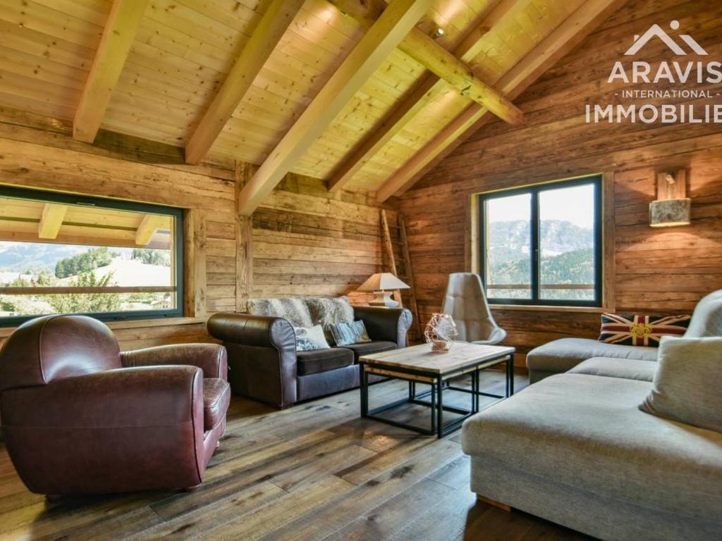 a living room with couches and chairs in a log cabin at Chalet Saint-Jean-de-Sixt, 6 pièces, 8 personnes - FR-1-391-75 in Saint-Jean-de-Sixt