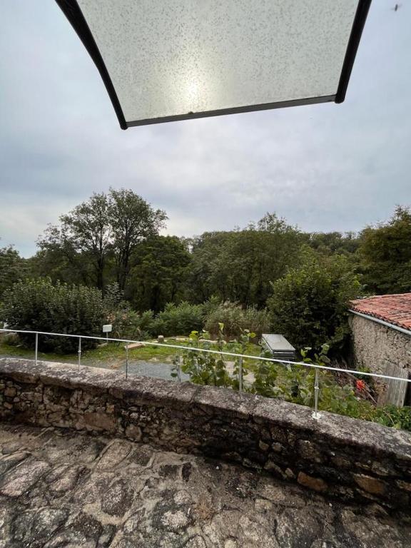 a view of a garden from a balcony of a house at Gîte les Pieds dans l&#39;eau bord de Sèvre, 10 min du Puy du Fo in Treize-Vents