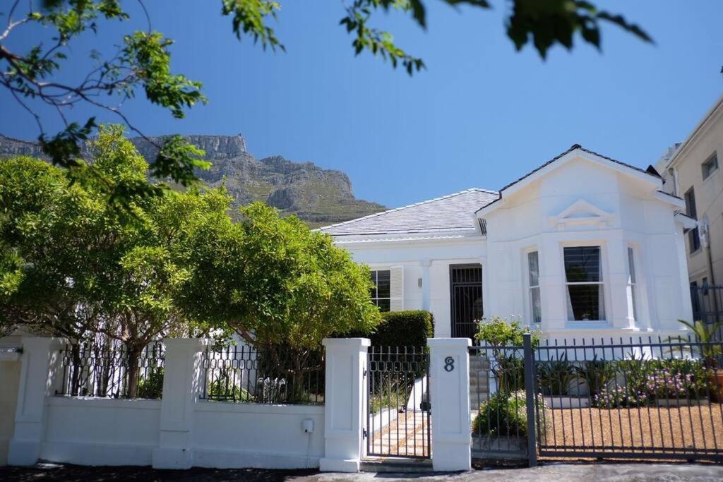a white house with a white fence at Gardens Retreat in Cape Town