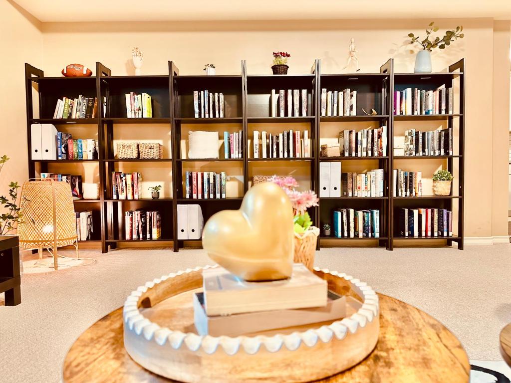 una biblioteca con una estatua del corazón sobre una mesa en Willoughby Heights 温馨卧房 en Langley