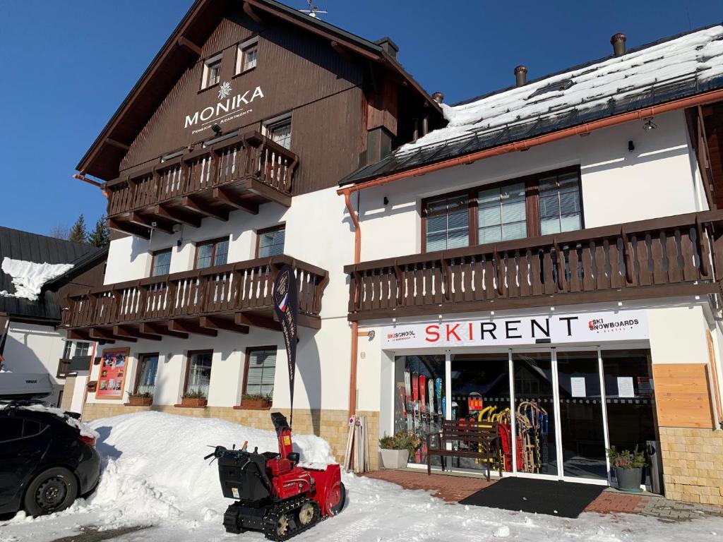 a snow machine parked in front of a ski resort at King size apartmán Pension Monika in Špindlerův Mlýn