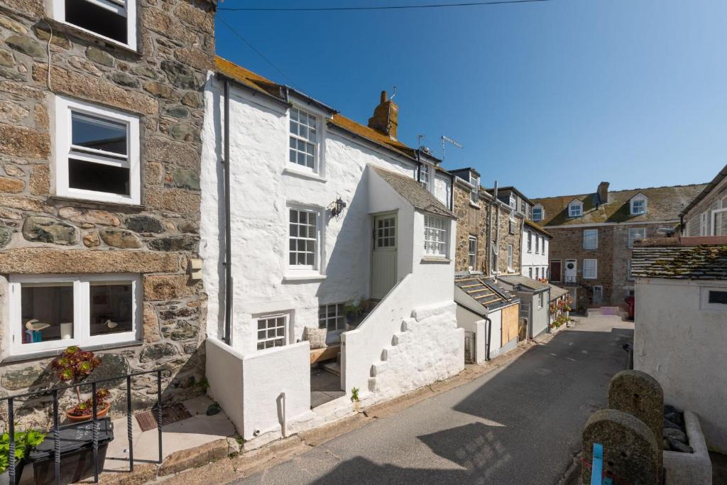 a view of a street in a village with buildings at Mariners Cottage, St Ives in St Ives
