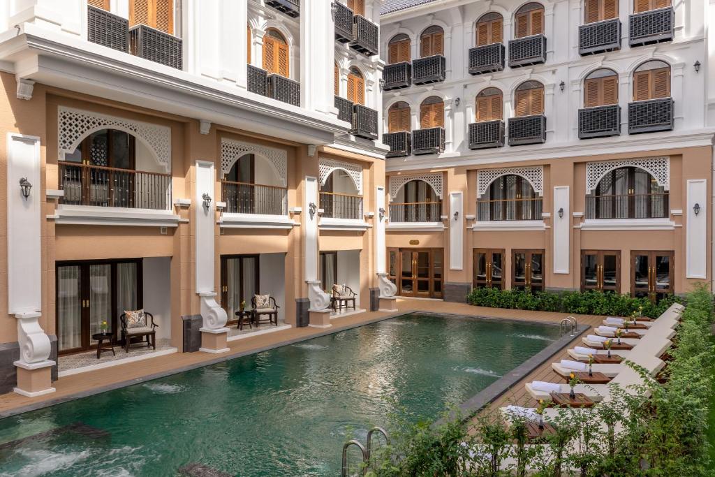 a pool in the courtyard of a building at CHINO@NIMMAN Luxury Boutique Hotel in Chiang Mai