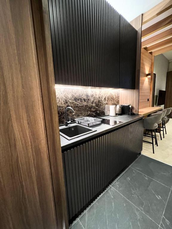 a kitchen with a sink and a counter top at Woodside 007 in Kopaonik