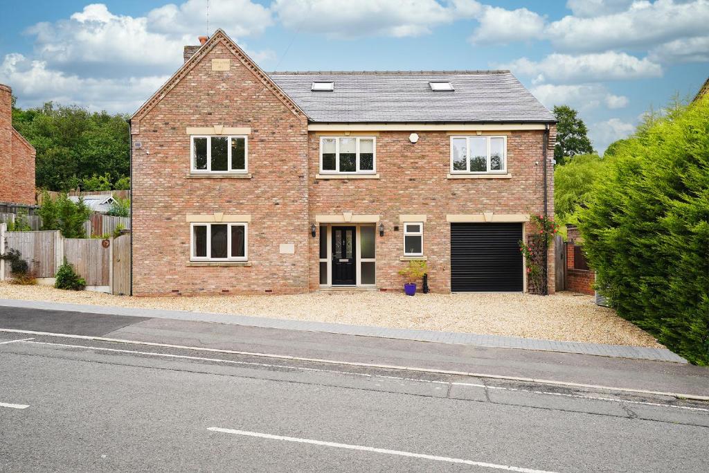 a brick house on the side of a road at Luxury Home with Hot Tub BBQ Pool Table in Chesterfield