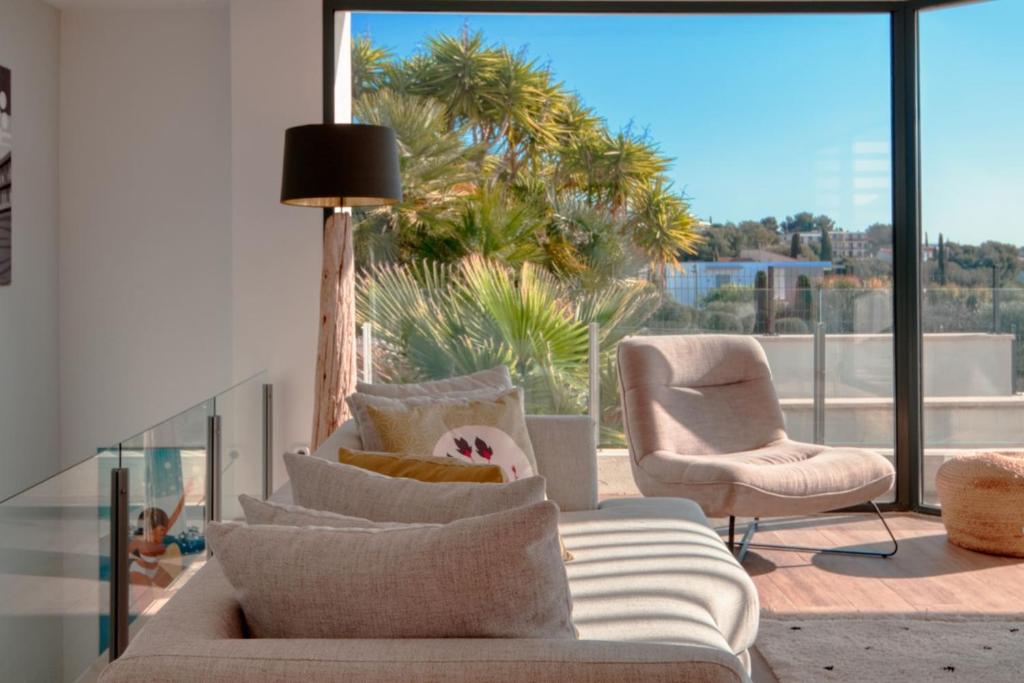 a living room with a couch and two chairs at Prestigious villa with panoramic sea view in Bandol