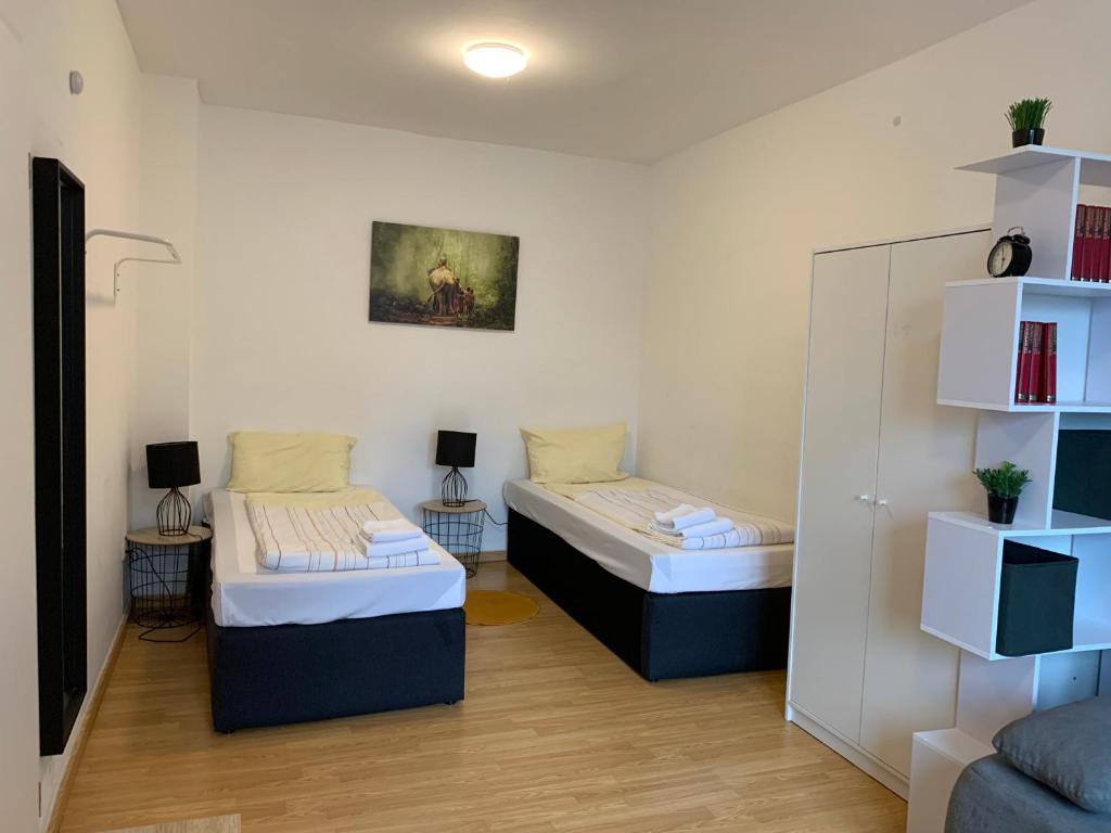 Säng eller sängar i ett rum på City Apartments direkt am Hauptbahnhof