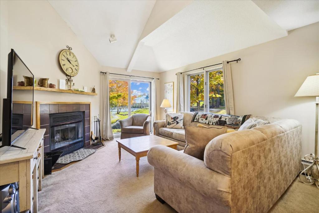 a living room with a couch and a fireplace at Woods V17 2-Bed & Loft with Fireplace, whirlpool tub, and sports center in Killington