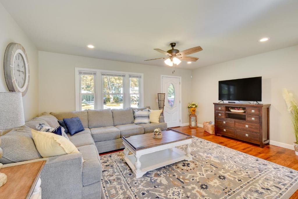 a living room with a couch and a tv at Greenville Vacation Rental - 3 Mi to Downtown! in Greenville