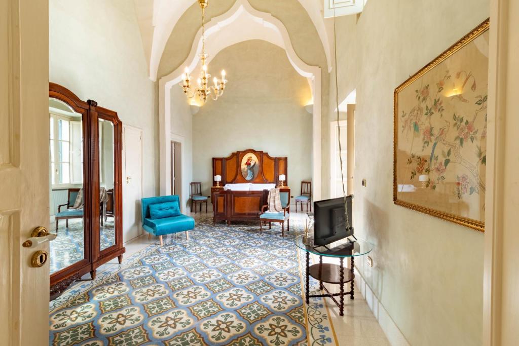 a hallway with a room with a tv and a living room at Palazzo Zacà in Gallipoli