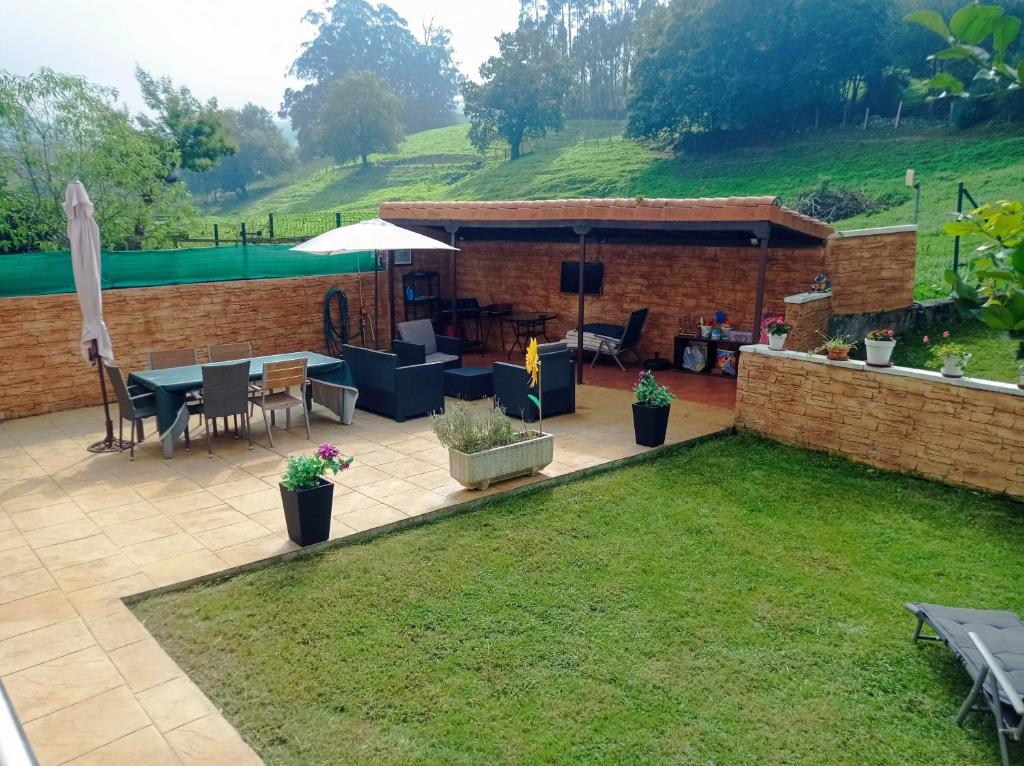 a patio with a table and chairs in a yard at La casa de Clara Puente Arce in Arce