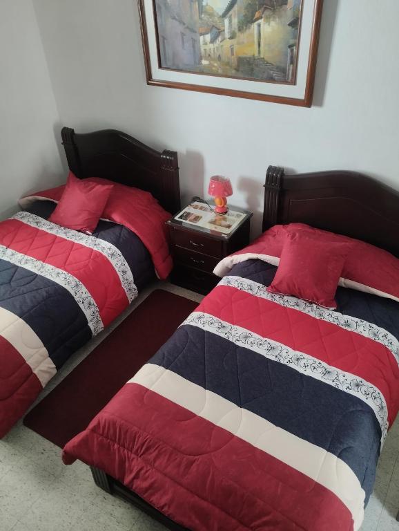 Postel nebo postele na pokoji v ubytování Hostal Flores