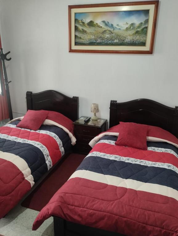 Postel nebo postele na pokoji v ubytování Hostal Flores
