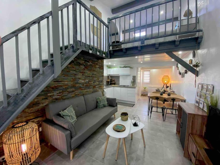 un salon avec un canapé et un escalier dans l'établissement Maison de vacances 4 étoiles, à Saint-Georges-de-Didonne