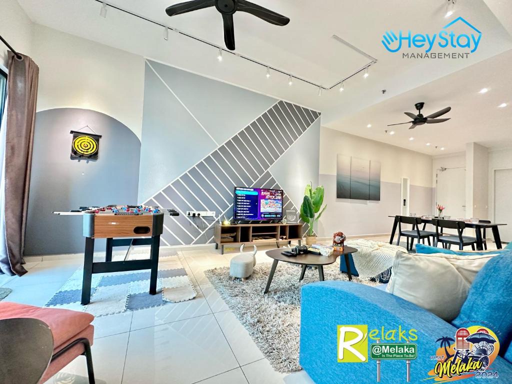 a living room with a blue couch and a table at OngKimWee Residence By Heystay Management in Melaka