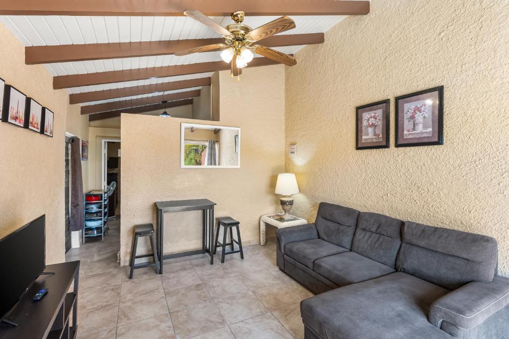 a living room with a couch and a ceiling fan at Caribbean View Style condo in Christiansted
