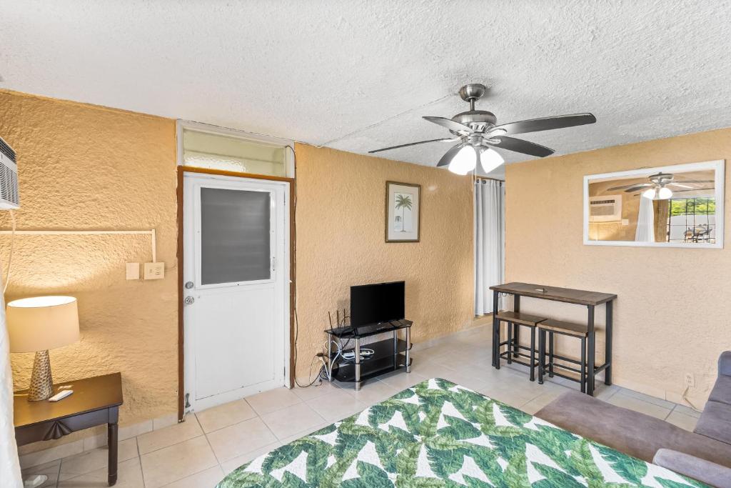 a living room with a ceiling fan and a television at Caribbean View condo in Christiansted