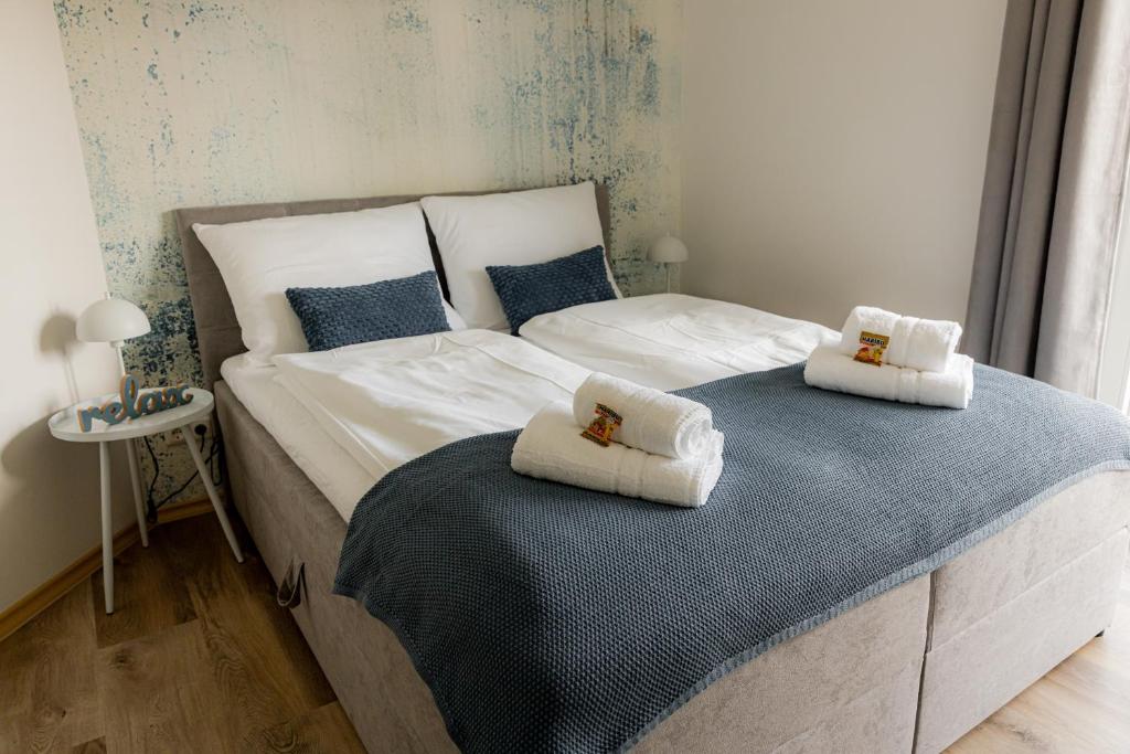 a bedroom with a large bed with towels on it at Come4Stay Passau - Wohnung Guby - 2 Zimmer I bis zu 4 Gäste in Passau