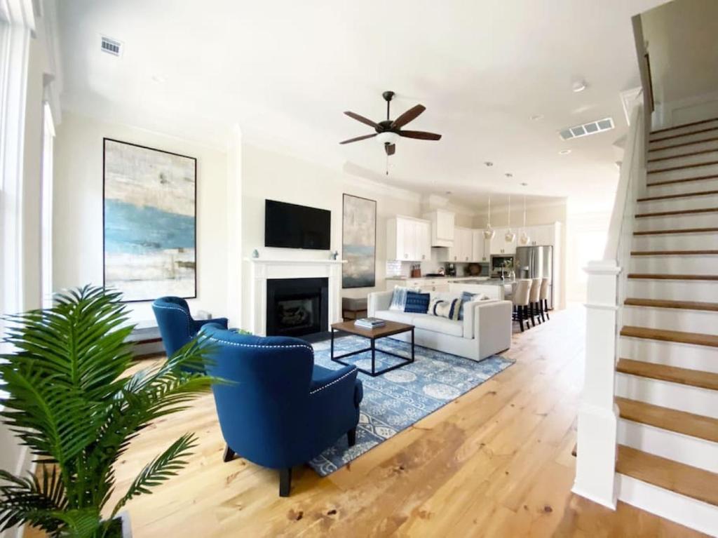 a living room with blue chairs and a fireplace at Magnolia Estate - 3 Separate Units, Courtyard in Savannah
