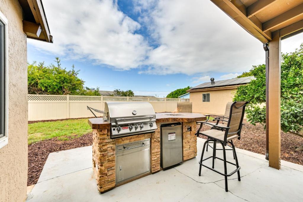 a backyard patio with a grill and a chair at Sunny San Diego Vacation Rental with Private Yard! in San Diego