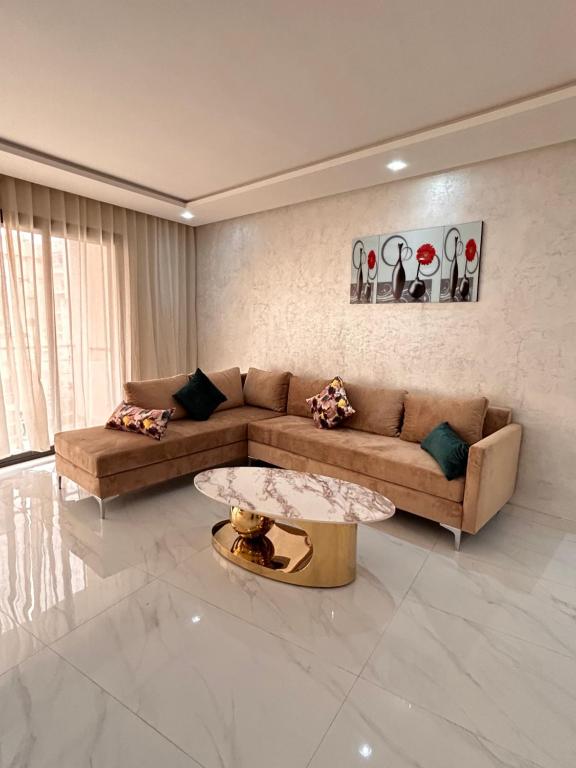 a living room with a couch and a coffee table at Maarif Elite Suites in Casablanca
