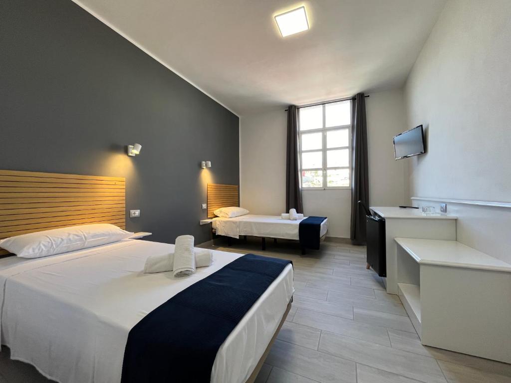 Postel nebo postele na pokoji v ubytování Hotel Pensión Cassandra