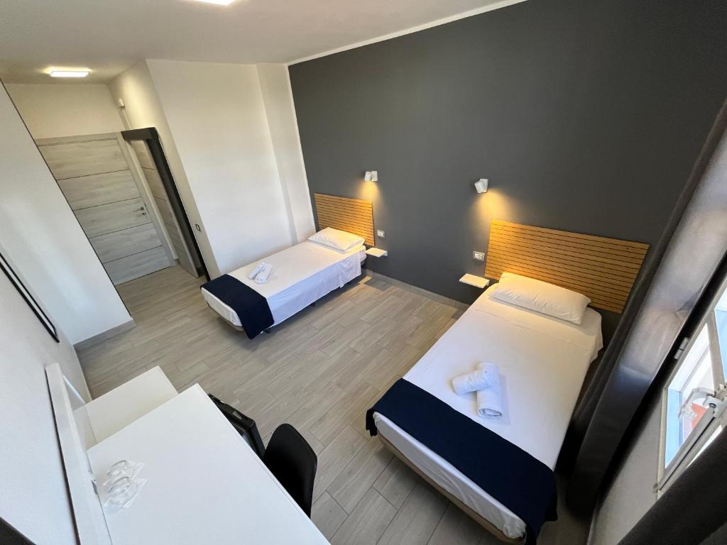 Postel nebo postele na pokoji v ubytování Hotel Pensión Cassandra