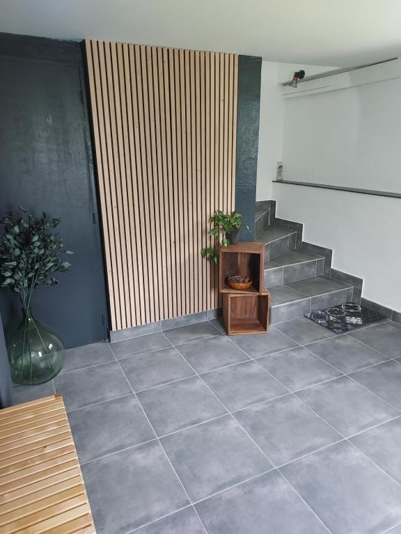 a room with a staircase with a table and a fireplace at le gite du Montcalm in Auzat