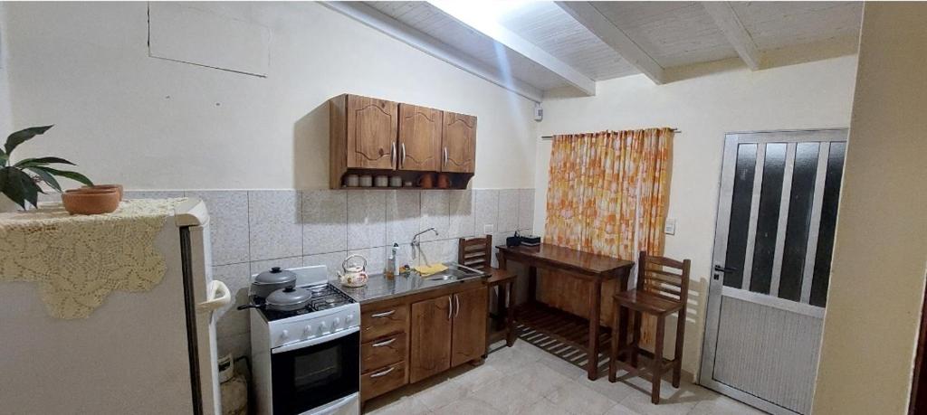 a kitchen with a sink and a stove top oven at LUZ BELLA in Oberá