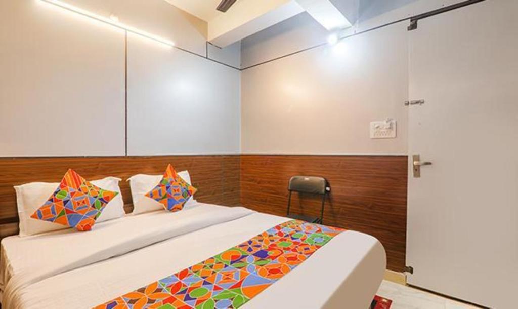 A bed or beds in a room at FabHotel Titiksha