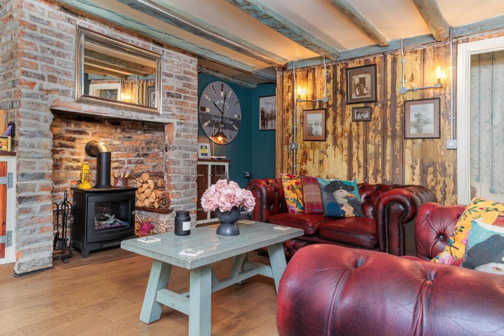 a living room with a couch and a fireplace at Boutique Fisherman's Cottage in Old Town in Scarborough