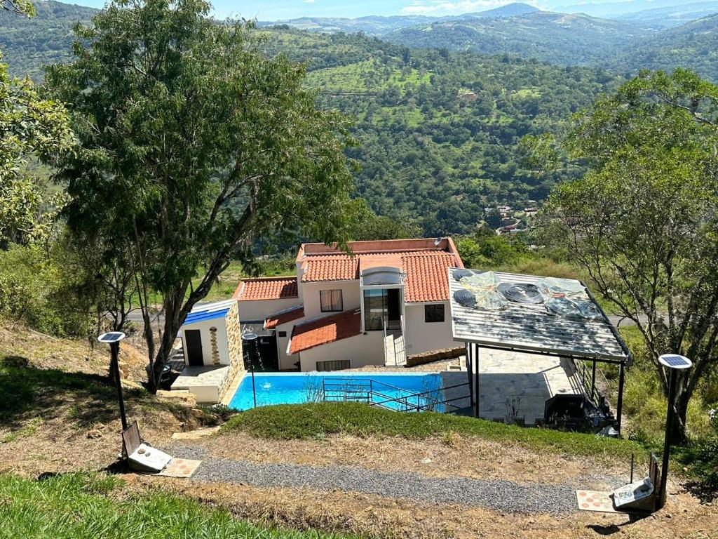 ein Haus auf einem Hügel mit Pool in der Unterkunft San Gil Villa 48 Palmaire in San Gil