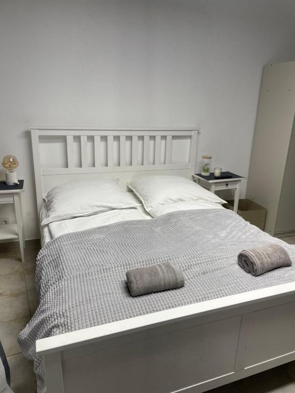 a white bed with two pillows on top of it at SleepWell1 in Cologne
