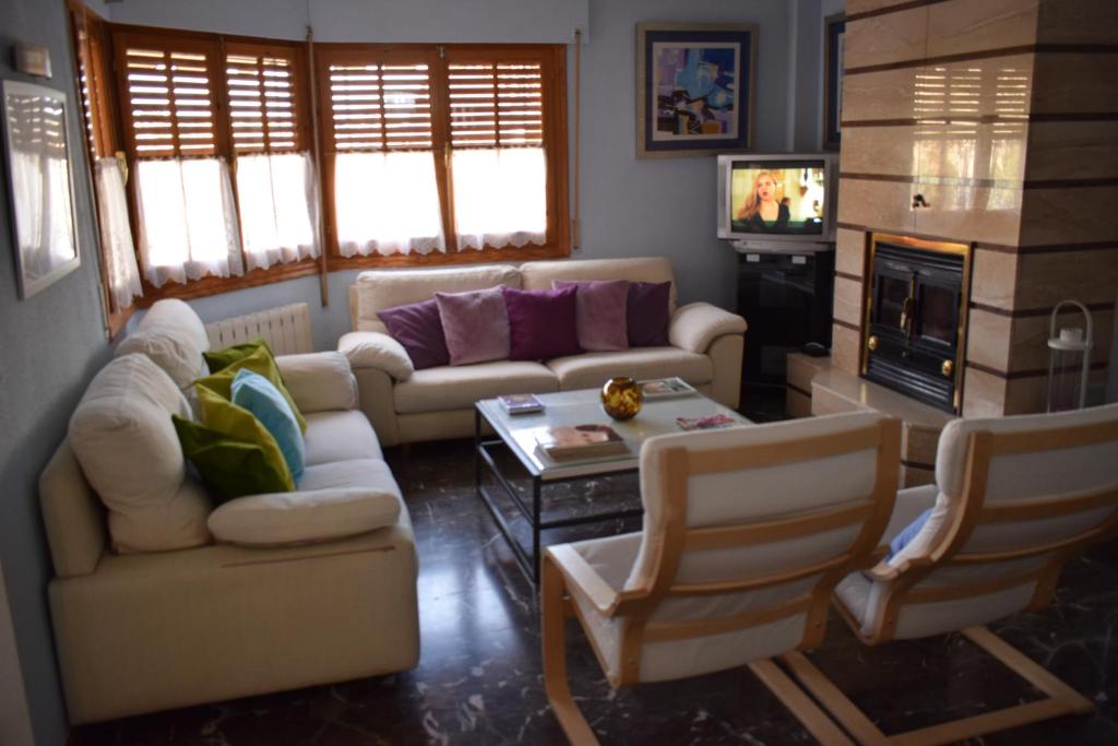 een woonkamer met 2 banken en een tv bij Alojamientos Villarias Archena 43 in Archena