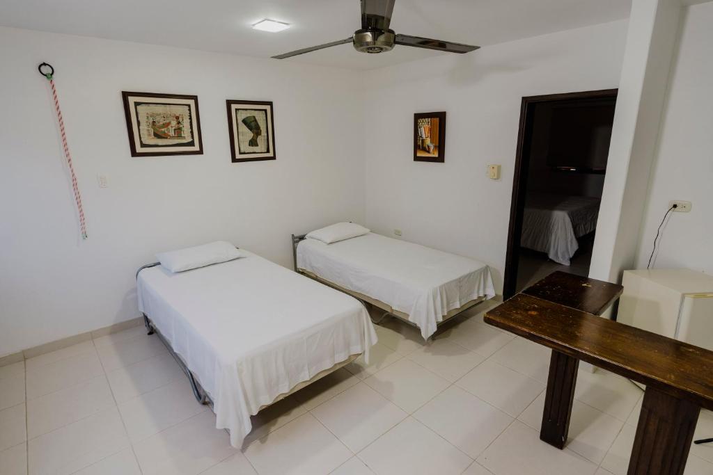 Postel nebo postele na pokoji v ubytování Hotel Rancho Regis