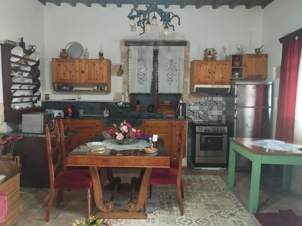 a kitchen with a wooden table and a dining room at TRADITIONAL HOUSE MARIA in Azoyirás
