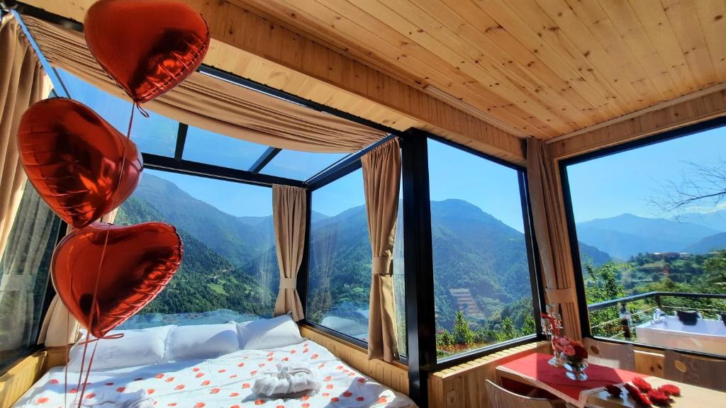 1 dormitorio con cama y ventana grande en Villa Machakhela●ვილა მაჭახელა en Batumi
