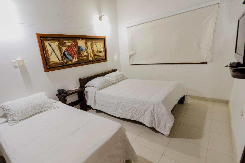 Postel nebo postele na pokoji v ubytování Hotel Rancho Regis