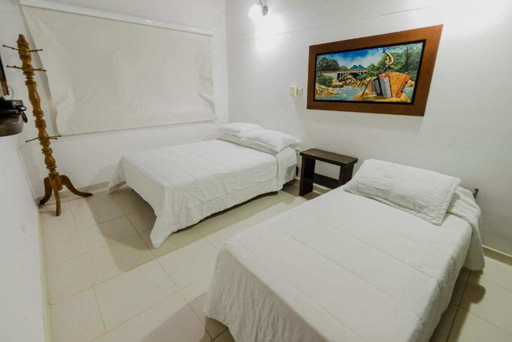 Postel nebo postele na pokoji v ubytování Hotel Rancho Regis