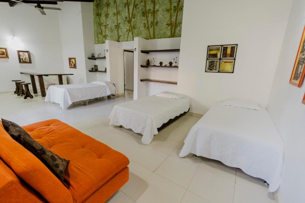Postel nebo postele na pokoji v ubytování Hotel Rancho Regis