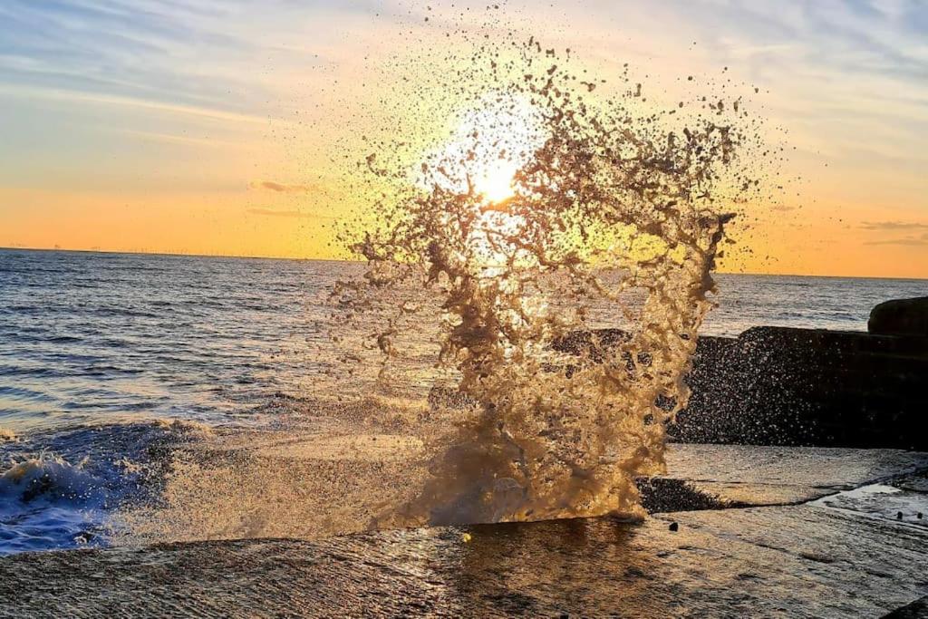 a splash of water in front of the ocean at House on Costal Village in Peacehaven