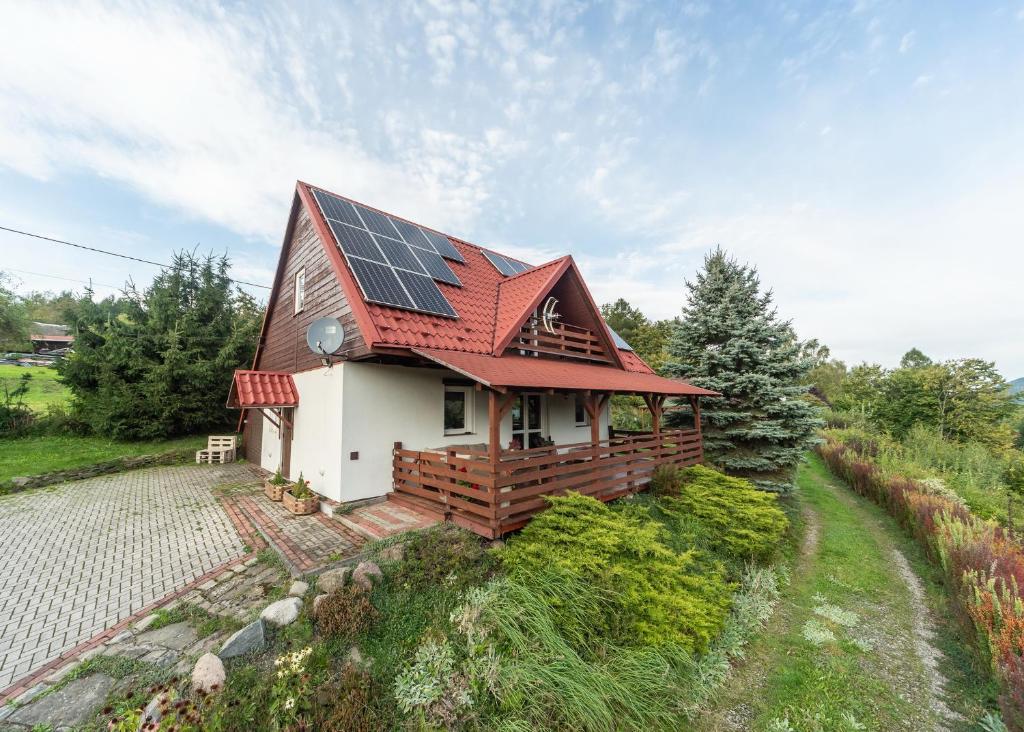 a house with solar panels on the roof at Domek na Hrobaczej in Międzybrodzie Bialskie