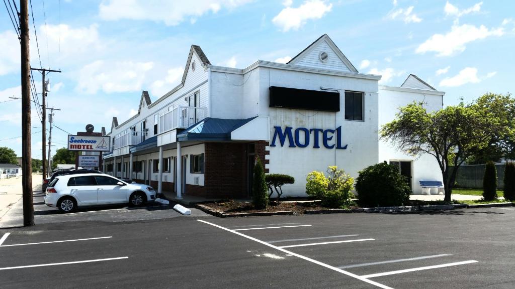 a car parked in a parking lot in front of a motel at Seabreeze Motel in Old Orchard Beach