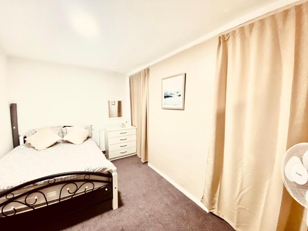 a white bedroom with a bed and a window at Spacious One bedroom apartment Edgeware Road Central London in London