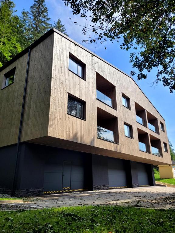 a concrete building with windows on the side of it at Apartmán Nicole in Tale