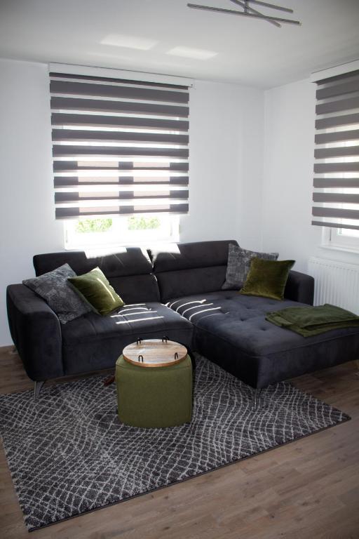 a living room with a couch and a coffee table at Ferienwohnung Wolf in Veringenstadt